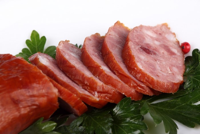 Sliced smoked ham with parsley and peppercorn
