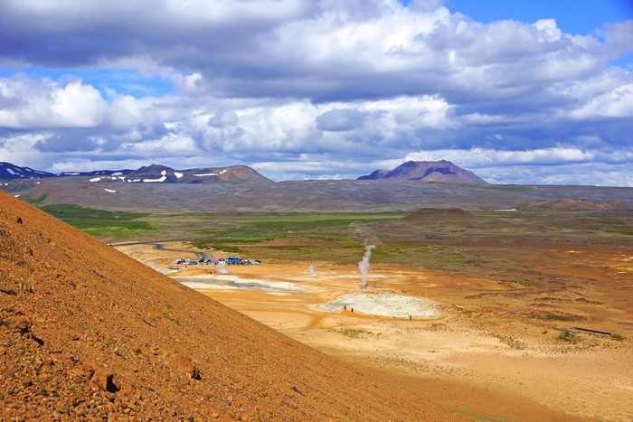 Geothermal area with steam vents and mountains in Iceland