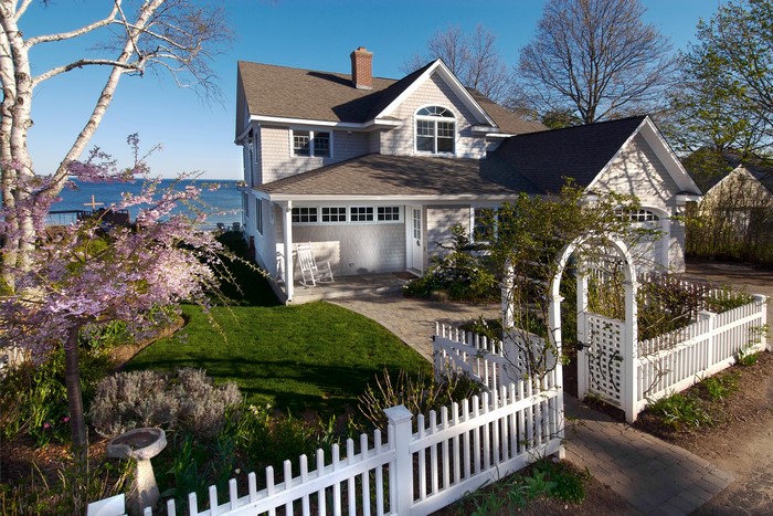 Coastal house with white picket fence and garden