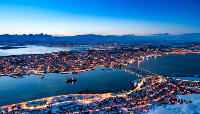 Tromso, Norway at night with snow and bridge
