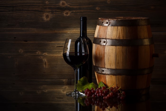 Wine bottle, glass, barrel, and grapes