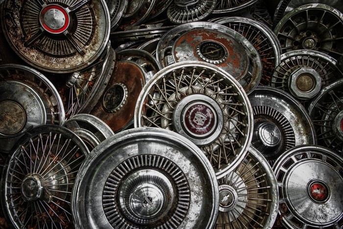 Pile of vintage car hubcaps and wheel covers
