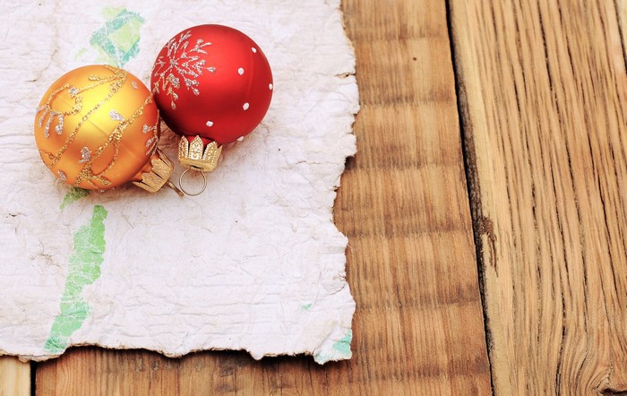 Christmas ornaments on textured paper and wood