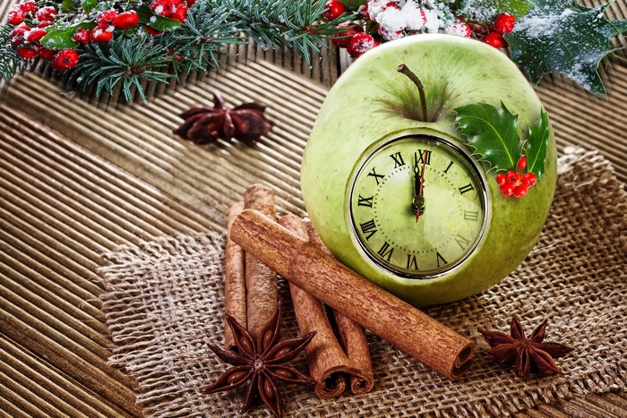 Christmas apple with clock and spices