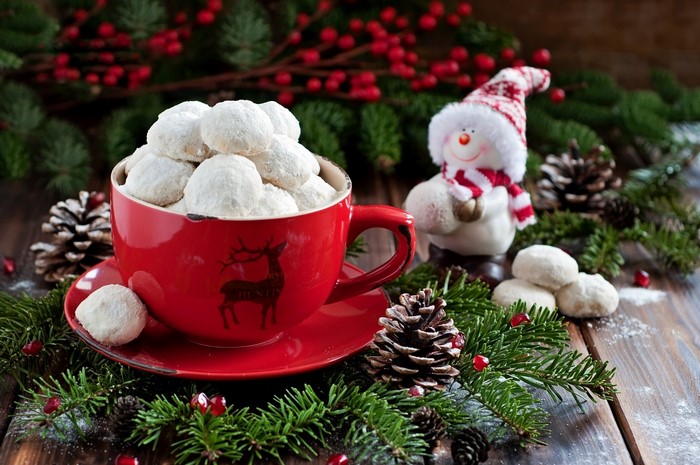 Christmas cookies in a red cup with a snowman decoration