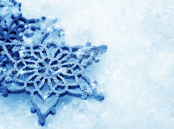 Close-up of a blue snowflake ornament on ice
