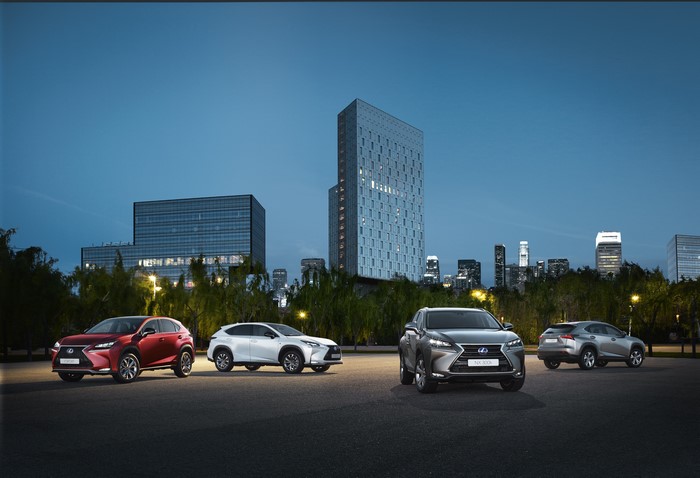 Lexus NX 300h F-Sport cars in a city at dusk