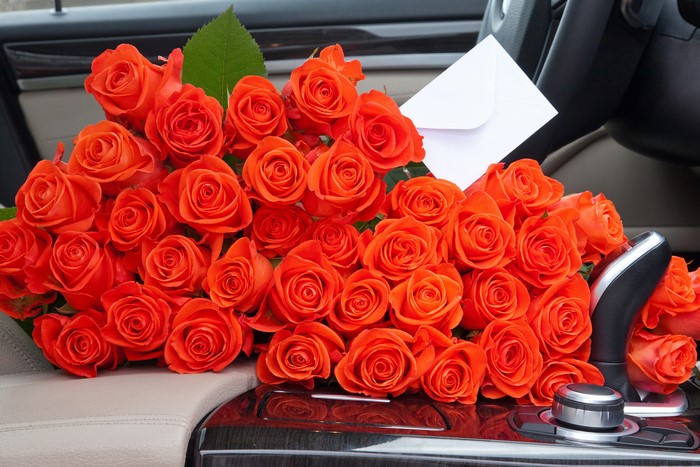 Bouquet of Orange Roses in a Car