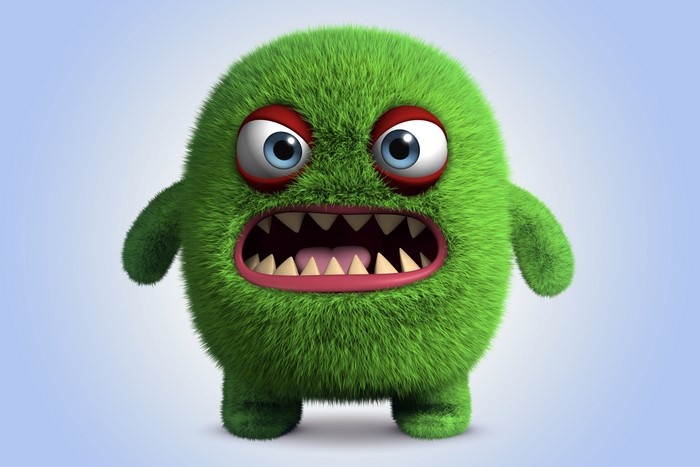 Green furry monster with sharp teeth