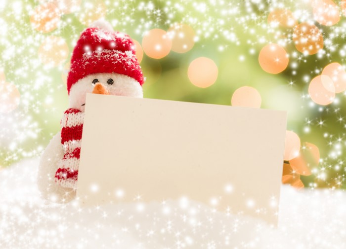 Snowman with a blank sign and Christmas lights