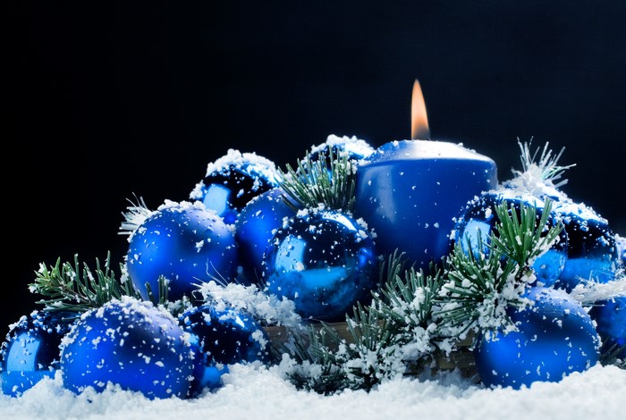 Christmas candle and ornaments with snow