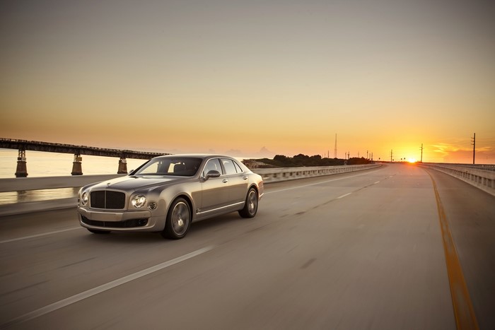 Bentley Mulsanne Speed driving on a bridge at sunset