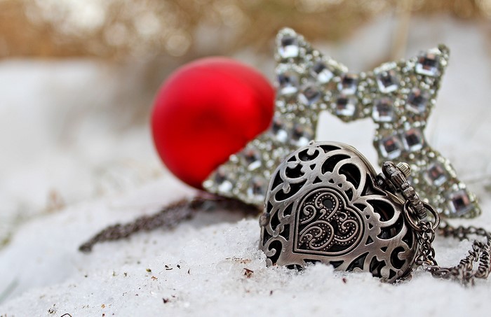 Heart pocket watch and Christmas ornaments in snow