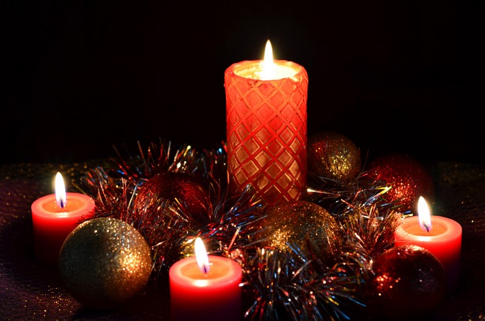 Christmas candles and ornaments with tinsel
