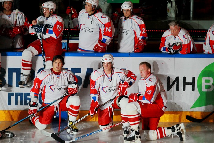Hockey players in uniform on the bench