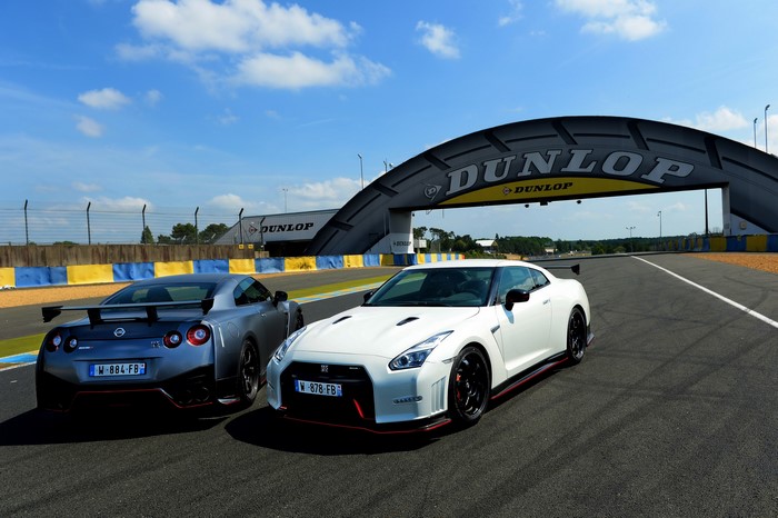 Two Nissan GT-R Nismo cars on a race track