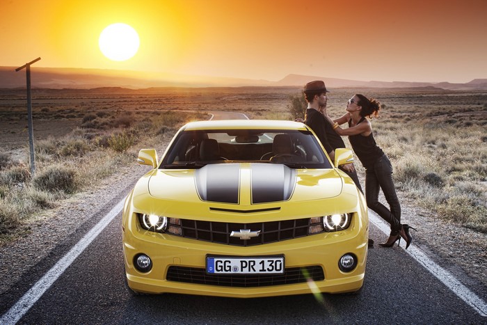 Yellow Chevrolet Camaro with Couple at Sunset