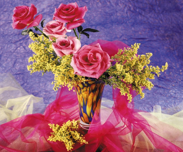 Pink roses and yellow flowers in a vase