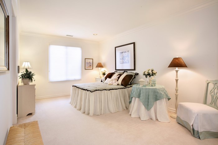 Bedroom with bed, lamps, and table
