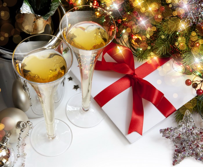 Champagne glasses with Christmas gift and decorations