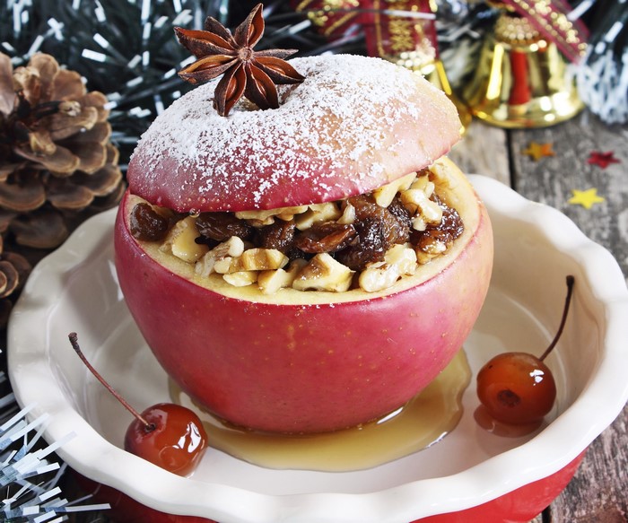 Baked apple with nuts and raisins, garnished with star anise