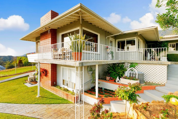 Two-story house with balcony and brick accents