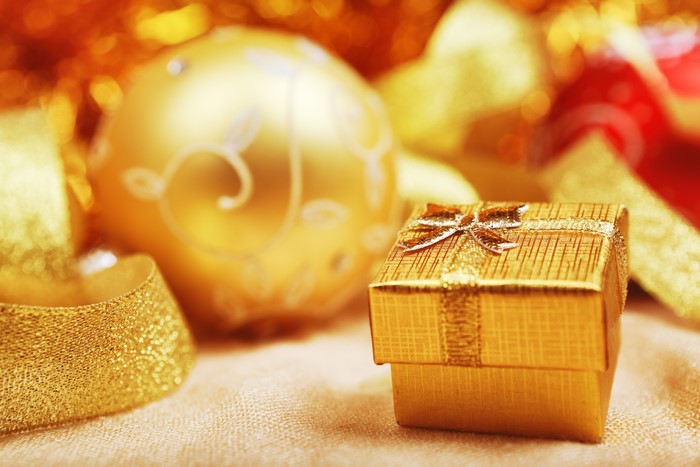Gold Christmas ornaments and gift box with ribbon