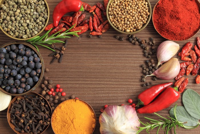 Assortment of Spices and Peppers on Wooden Table