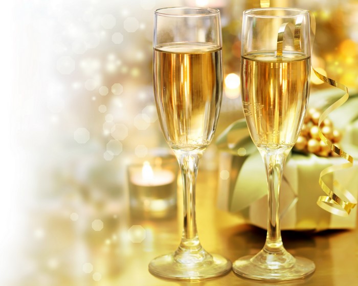 Champagne glasses with gifts and candle