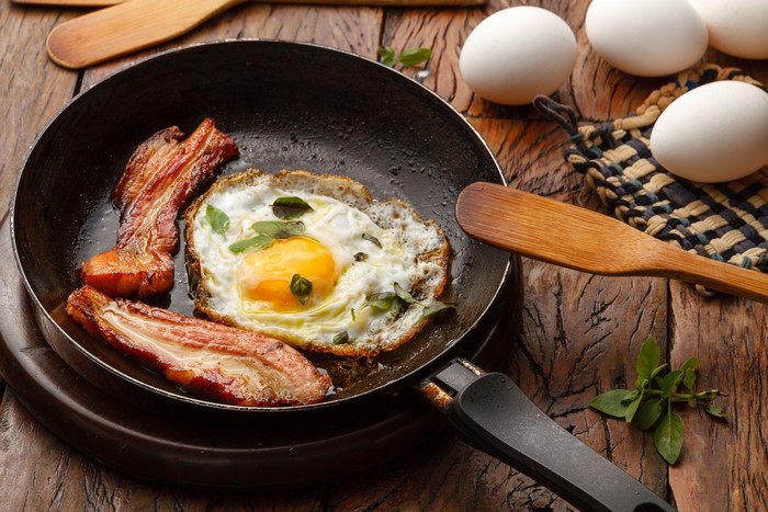 Fried egg and bacon in a frying pan