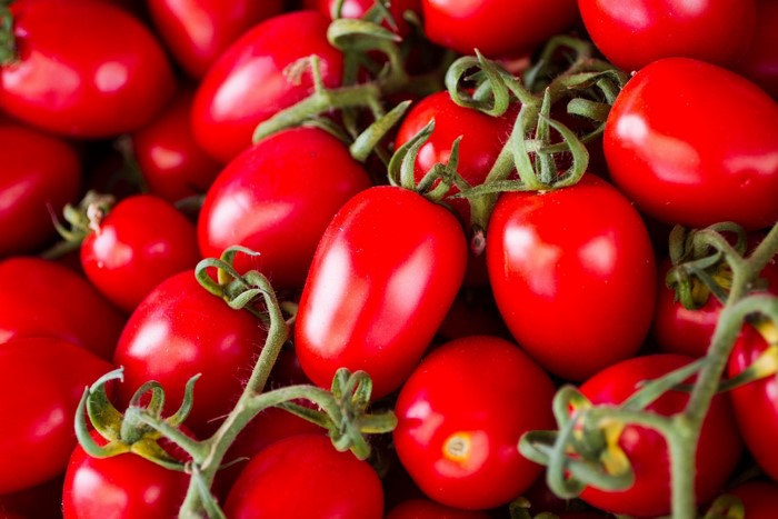A pile of ripe red Roma tomatoes