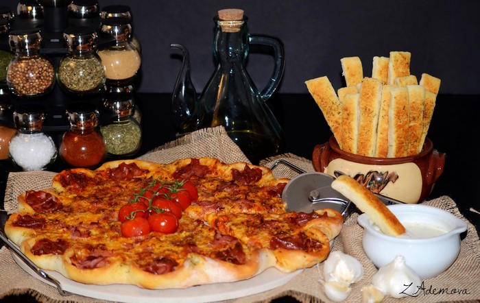 Pizza with breadsticks and spices
