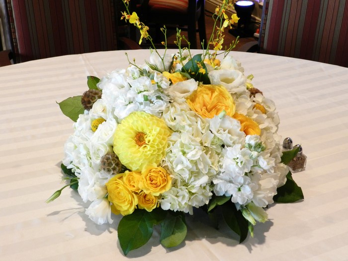 Yellow and white floral arrangement with dahlias and roses