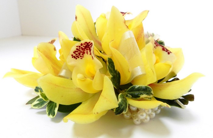 Yellow orchids with pearls and greenery