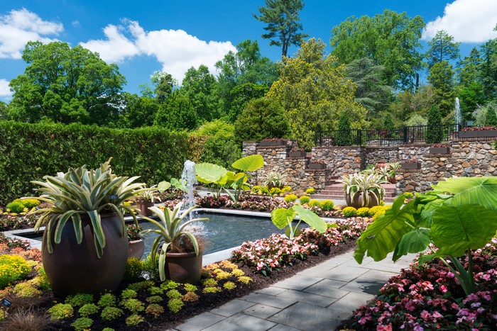 Garden with fountain and stone wall