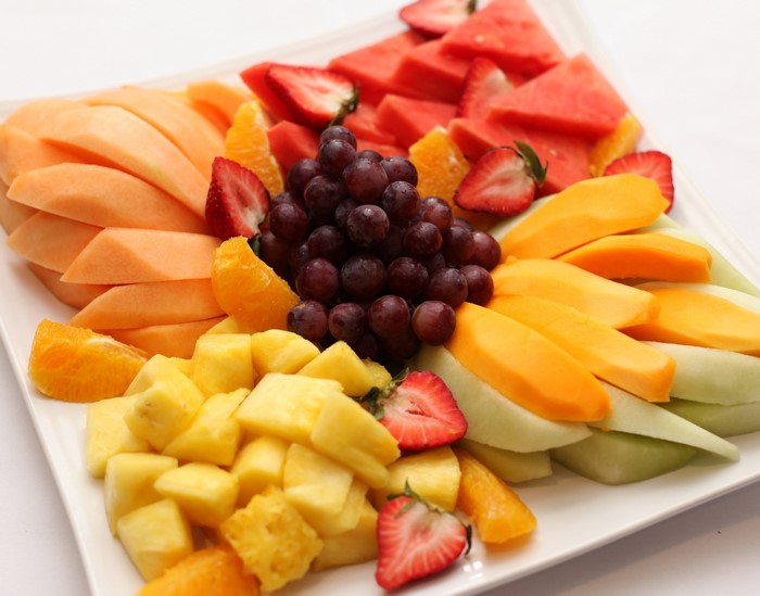 Fruit platter with grapes, strawberries, melon, and pineapple