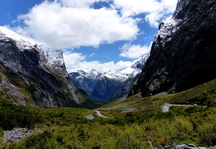 Valley with snow-capped mountains and a winding road