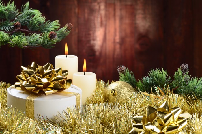 Christmas gift with candles and pine branches