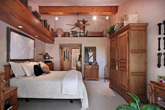 Bedroom with wooden furniture and artwork