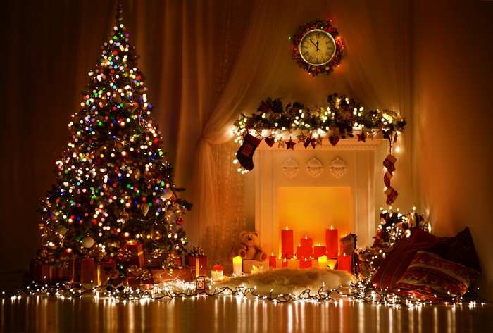 Christmas tree and fireplace with candles and fairy lights