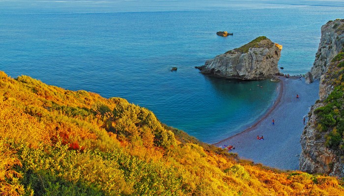 Kaladi Beach, Greece, with rocky outcrops and clear blue sea