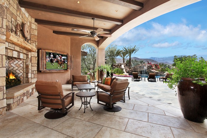 Outdoor living space with fireplace and pool