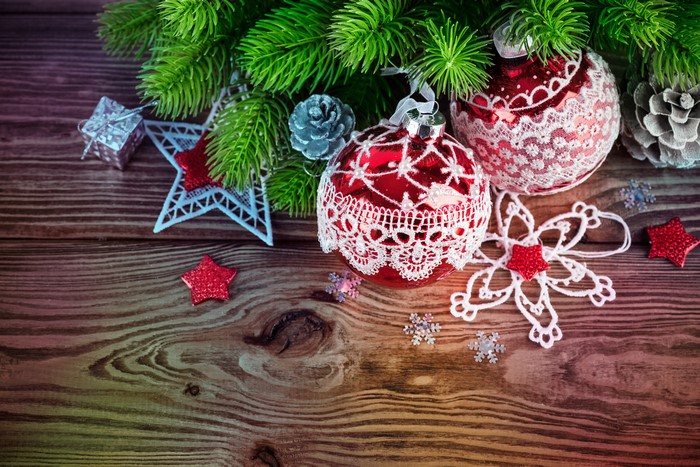 Christmas Ornaments and Pine Branches on Wood