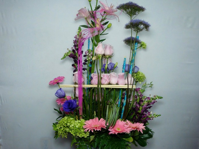 Floral arrangement with roses, lilies, and gerberas