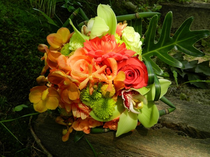 Tropical flower bouquet with orchids and roses