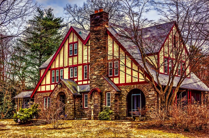 American Tudor House with Stone Chimney and Red Trim