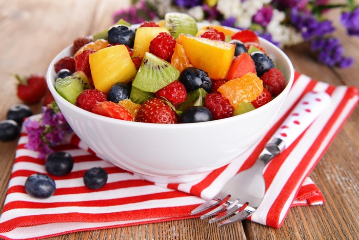 Fruit salad with strawberries, raspberries, kiwi, blueberries, and oranges