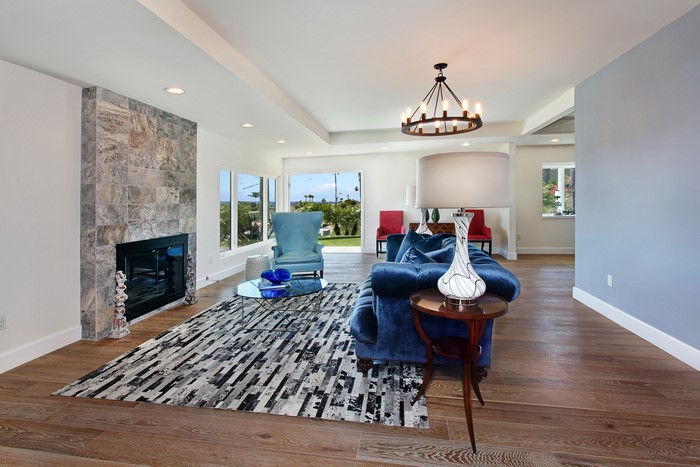 Living room with fireplace, chandelier, and sofa