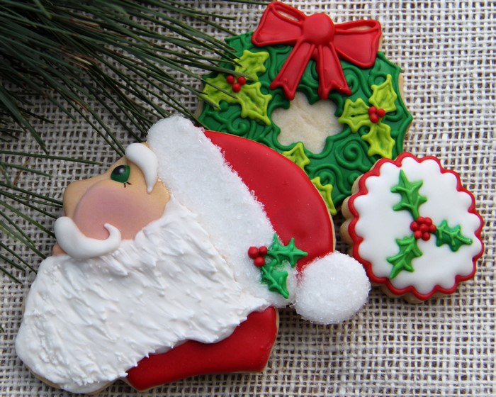 Christmas cookies with Santa Claus and holly wreaths