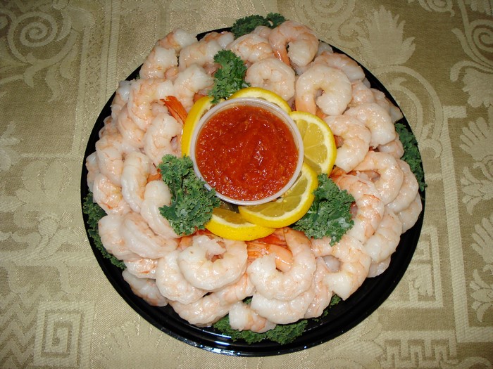 Shrimp platter with cocktail sauce and lemon slices